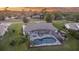 A beautiful sunset view of the back of a house with a screened-in pool and deck at 425 N Pine Meadow Dr, Debary, FL 32713