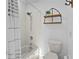 Bathroom featuring white tiled shower/tub combination, decorative shelf, and toilet at 425 N Pine Meadow Dr, Debary, FL 32713