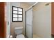 Compact bathroom featuring a shower, toilet, and classic patterned wallpaper at 425 N Pine Meadow Dr, Debary, FL 32713