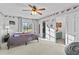 Spacious bedroom with a ceiling fan, ensuite bathroom, and ample natural light at 425 N Pine Meadow Dr, Debary, FL 32713