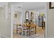Open dining area featuring farmhouse table, mirror, stainless steel appliances, and ample natural light at 425 N Pine Meadow Dr, Debary, FL 32713