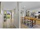 Open-concept home featuring a tiled entryway, dining area, and a glimpse of a modern kitchen layout at 425 N Pine Meadow Dr, Debary, FL 32713