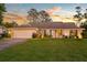 Inviting single-story home with a lush front lawn, brick facade, and an attached garage on a large grassy lot at 425 N Pine Meadow Dr, Debary, FL 32713