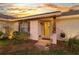 Close-up of a brick home's inviting front porch with a glass front door and decorative wooden shutters at 425 N Pine Meadow Dr, Debary, FL 32713