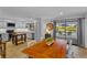 Bright, open kitchen with modern appliances, a dining table, and sliding doors leading to an outdoor pool area at 425 N Pine Meadow Dr, Debary, FL 32713