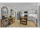 Well-lit kitchen featuring stainless steel appliances, light gray cabinetry, and stylish wooden furniture at 425 N Pine Meadow Dr, Debary, FL 32713