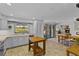 Bright kitchen with white cabinetry, tile backsplash, and a functional wooden island at 425 N Pine Meadow Dr, Debary, FL 32713