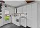 Bright laundry room with washer, dryer, sink, storage, and outdoor access at 425 N Pine Meadow Dr, Debary, FL 32713