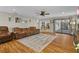 Open living room with hardwood floors, comfortable sofa, and view into the kitchen at 425 N Pine Meadow Dr, Debary, FL 32713