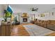 Cozy living room with a brick fireplace, hardwood floors, and comfortable seating at 425 N Pine Meadow Dr, Debary, FL 32713