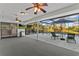 Screened-in patio with ceiling fans, TV, lounge chairs, and view of the pool at 425 N Pine Meadow Dr, Debary, FL 32713