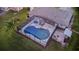 Aerial view of a screened-in pool and deck, complete with outdoor lounge furniture and grilling area at 425 N Pine Meadow Dr, Debary, FL 32713
