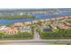 Gorgeous aerial view of waterfront condos with lush landscaping, a highway nearby and scenic waterway views at 445 Bouchelle Dr # 104, New Smyrna Beach, FL 32169