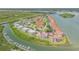 Stunning aerial view of waterfront condos with red tile roofs and a marina on a green waterway at 445 Bouchelle Dr # 104, New Smyrna Beach, FL 32169