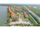 Aerial view showcases waterfront condos with boat parking, lush landscaping, and convenient highway access at 445 Bouchelle Dr # 104, New Smyrna Beach, FL 32169