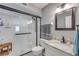 Contemporary bathroom with walk-in shower, black hardware, and granite vanity with white cabinets at 445 Bouchelle Dr # 104, New Smyrna Beach, FL 32169