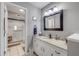 Bright bathroom featuring granite countertop, white cabinets, and a tiled walk-in shower at 445 Bouchelle Dr # 104, New Smyrna Beach, FL 32169