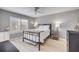 Serene bedroom with a metal frame bed, light wood flooring, and ample natural light at 445 Bouchelle Dr # 104, New Smyrna Beach, FL 32169