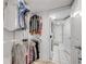 Walk-in closet with rod and shelves for storage, adjoining laundry room with washer and dryer at 445 Bouchelle Dr # 104, New Smyrna Beach, FL 32169