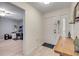 Inviting entryway with white door, light wood floors, and view to office space at 445 Bouchelle Dr # 104, New Smyrna Beach, FL 32169