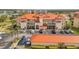 Stunning condo building features a bright orange tile roof and well-maintained landscaping at 445 Bouchelle Dr # 104, New Smyrna Beach, FL 32169