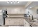 Kitchen featuring white cabinets, granite countertops, and stainless steel appliances at 445 Bouchelle Dr # 104, New Smyrna Beach, FL 32169