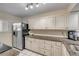 Kitchen featuring white cabinets, granite countertops, and stainless steel refrigerator at 445 Bouchelle Dr # 104, New Smyrna Beach, FL 32169