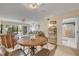 Open-concept living area with a dining table, comfortable seating, and access to the lanai at 445 Bouchelle Dr # 104, New Smyrna Beach, FL 32169