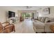 Comfortable living room with entertainment center and sliding glass doors to the outdoor space at 445 Bouchelle Dr # 104, New Smyrna Beach, FL 32169