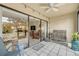 Relaxing covered patio with tiled floor and comfortable seating, perfect for enjoying the outdoors at 445 Bouchelle Dr # 104, New Smyrna Beach, FL 32169