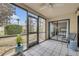 Screened-in lanai with a view of well-maintained landscaping and access to the outdoors at 445 Bouchelle Dr # 104, New Smyrna Beach, FL 32169