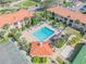Aerial view of community pool with ample seating, providing a refreshing oasis for residents to relax and socialize at 445 Bouchelle Dr # 104, New Smyrna Beach, FL 32169