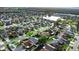 Expansive aerial view of a residential neighborhood with houses, trees, and a nearby pond at 4618 Prairie Point, Kissimmee, FL 34746