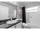 Bathroom featuring a tub and shower combo with black shower curtain and vanity with dark countertop at 4618 Prairie Point, Kissimmee, FL 34746
