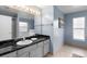 Bathroom showcasing vanity with granite countertop, mirror, and fixtures, tiled floors and blue walls at 4618 Prairie Point, Kissimmee, FL 34746