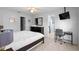 Bedroom with black dresser, black bed frame with white bedding, desk, and tiled flooring at 4618 Prairie Point, Kissimmee, FL 34746
