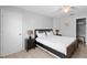 Cozy bedroom featuring a black bed frame with white bedding, matching nightstands, and tiled flooring at 4618 Prairie Point, Kissimmee, FL 34746