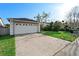 View of the home's front, including a two-car garage and well-maintained lawn and landscaping at 4618 Prairie Point, Kissimmee, FL 34746
