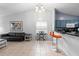 Bright living room features tile floors, piano keyboard, black leather sofa, and counter top bar with stools at 4618 Prairie Point, Kissimmee, FL 34746