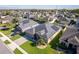 Expansive aerial view of home in a neighborhood with a paver driveway and solar panels on the roof at 4862 Grand Vista Ln, St Cloud, FL 34771