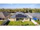 Aerial of the home's rear, showing solar panels and a manicured lawn and landscaping at 4862 Grand Vista Ln, St Cloud, FL 34771