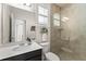 Bright bathroom with a glass shower, white countertops, and dark vanity cabinets at 4862 Grand Vista Ln, St Cloud, FL 34771