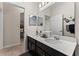 This well-lit bathroom includes a dual sink vanity with a decorative mirror and neutral wall color at 4862 Grand Vista Ln, St Cloud, FL 34771