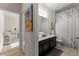This bright bathroom boasts a dual sink vanity with a sleek countertop and decorative shower curtain at 4862 Grand Vista Ln, St Cloud, FL 34771