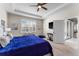 Bright bedroom with tray ceilings, carpet flooring, plantation shutters, and ensuite bathroom access at 4862 Grand Vista Ln, St Cloud, FL 34771