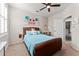 This cozy bedroom features a ceiling fan, decorative pillows, and soft natural light filtering through the blinds at 4862 Grand Vista Ln, St Cloud, FL 34771