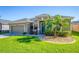 Charming one-story home featuring a well-manicured lawn, a two-car garage, and a blue front door at 4862 Grand Vista Ln, St Cloud, FL 34771