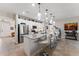 Open kitchen featuring stainless steel appliances, eat-in island, and convenient access to the adjacent living spaces at 4862 Grand Vista Ln, St Cloud, FL 34771