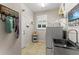 Functional laundry room equipped with a utility sink, washer, dryer, and shelving for storage at 4862 Grand Vista Ln, St Cloud, FL 34771