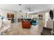 Open-concept living room with tile floors, comfortable seating, and sliding glass doors to the outdoor patio at 4862 Grand Vista Ln, St Cloud, FL 34771